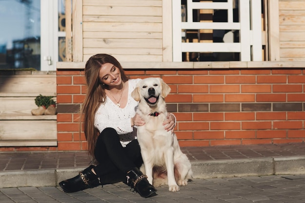 屋外の犬と若い幸せな女性