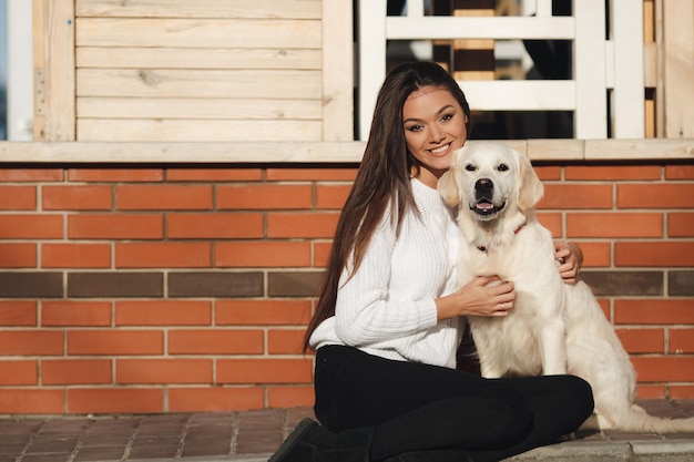 Free photo young happy woman with dog outdoor