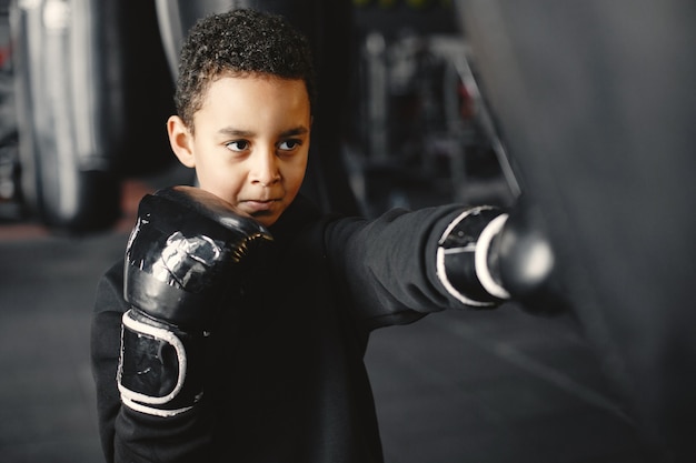 Young hardworking boxer learning to box. Child at sport center. Kid taking up a new hobby