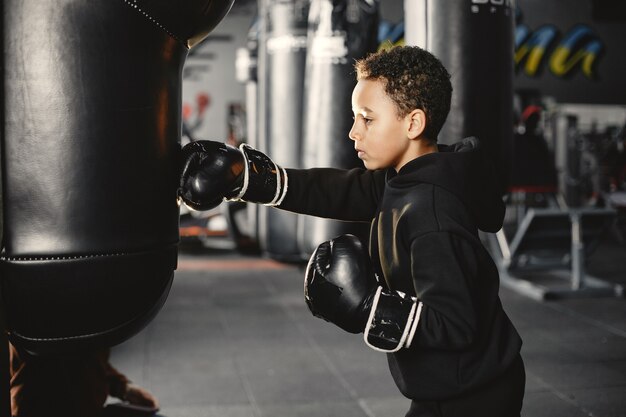 Young hardworking boxer learning to box. Child at sport center. Kid taking up a new hobby