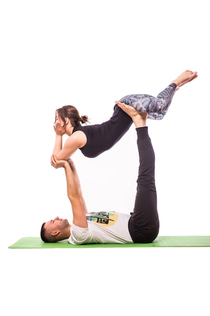 Young healthy couple in yoga position isolated on white background