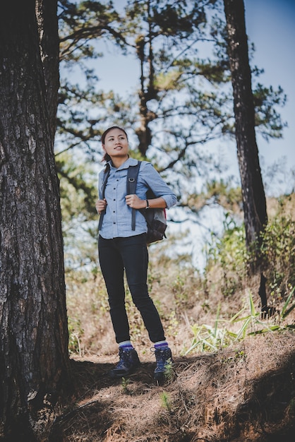 Young hiker woman take a rest while hiking to the mountain. Adventure holiday concept.