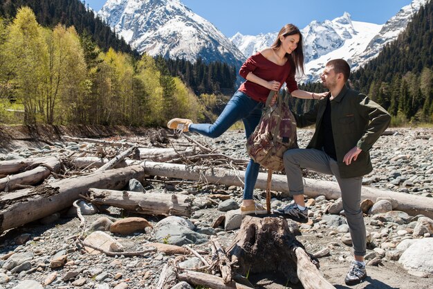 Young hipster beautiful couple hiking at river in forest