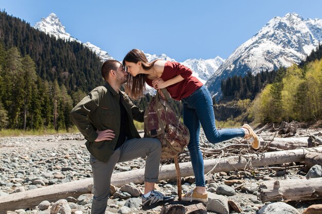 Young hipster beautiful couple hiking at river in forest