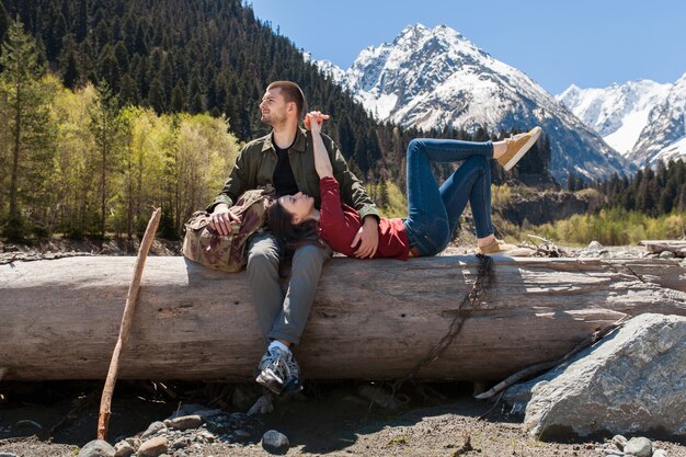 Young hipster beautiful couple hiking at river in forest