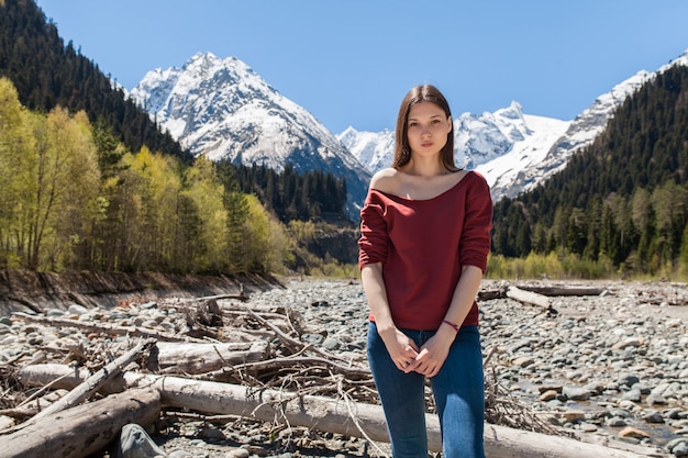 Free photo young hipster beautiful woman at river in forest