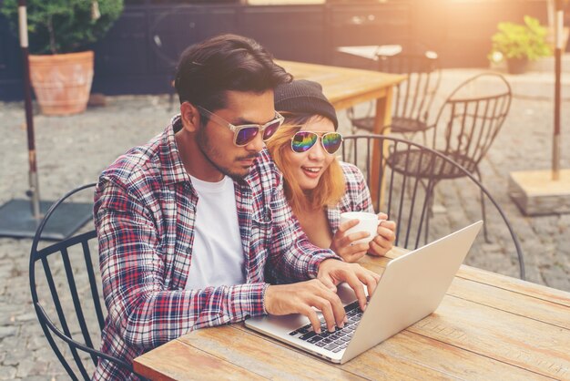 Young hipster couple drinking talking having fun laughing smilin