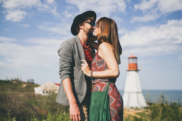 Young hipster couple kissing in the countryside