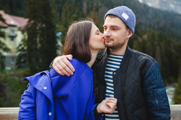 Young hipster couple in love on winter vacation in mountains