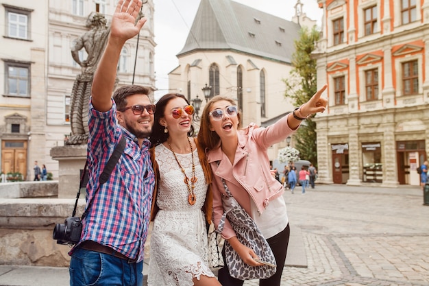 Young hipster friends posing in old town