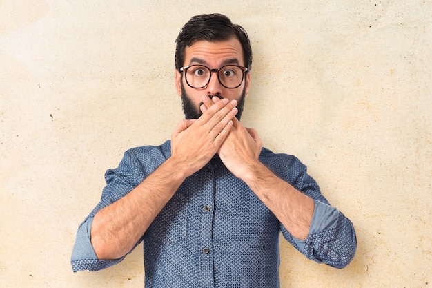 Free photo young hipster man doing surprise gesture