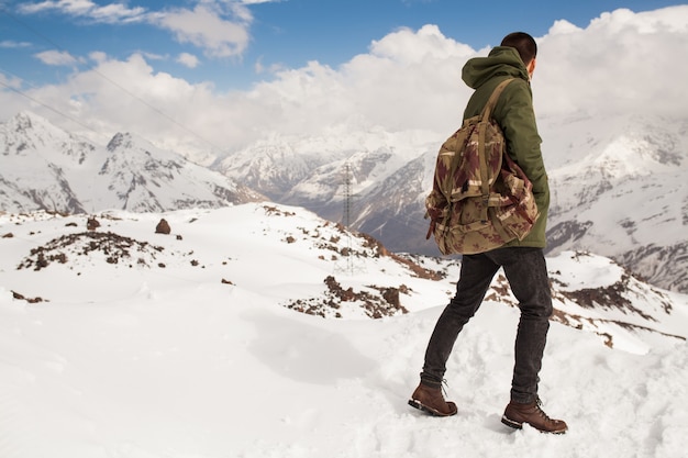 山でハイキング、流行に敏感な若い男、冬の休暇旅行