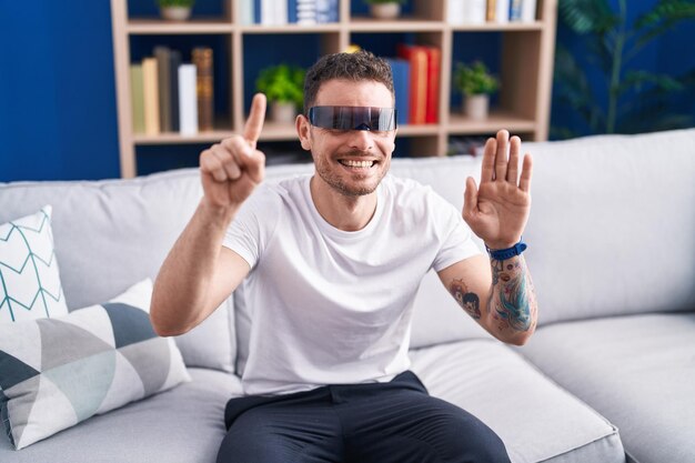 Free photo young hispanic man playing video game using virtual reality glasses at home