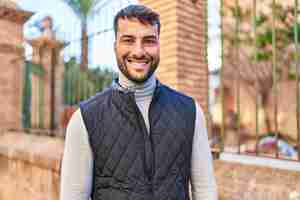 Free photo young hispanic man smiling confident standing at street