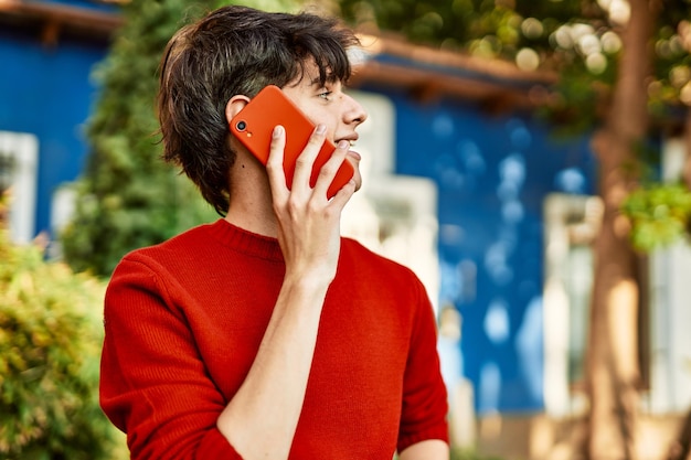 Free photo young hispanic man smiling happy talking on the smartphone at the city