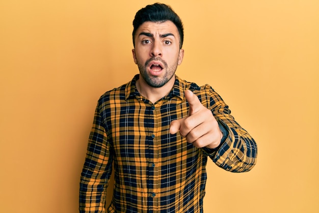 Young hispanic man wearing casual clothes pointing displeased and frustrated to the camera, angry and furious with you