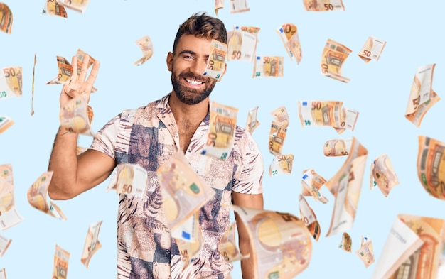 Free Photo young hispanic man wearing summer clothes showing and pointing up with fingers number four while smiling confident and happy.
