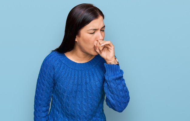 Young hispanic woman wearing casual clothes feeling unwell and coughing as symptom for cold or bronchitis health care concept