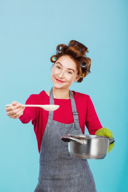 Young housewife gives you ladle to try homemade soup