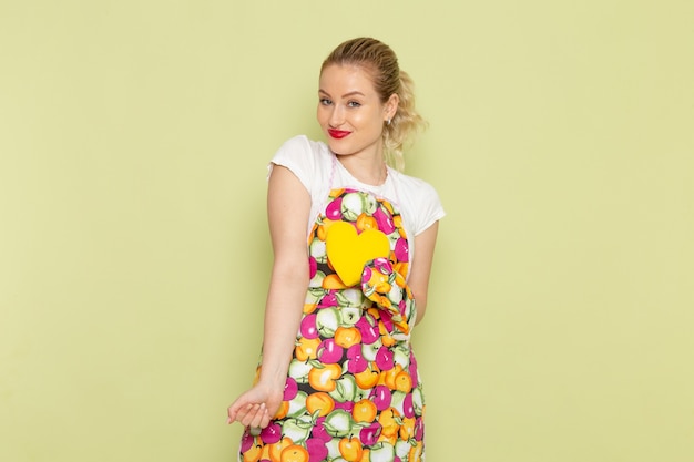 young housewife in shirt and colored cape just posing and standing on green