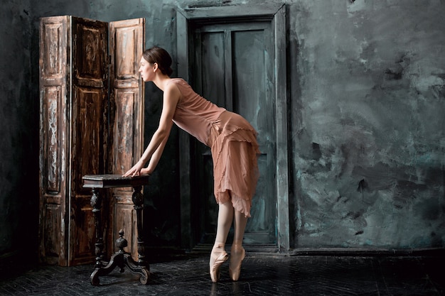 Free photo young and incredibly beautiful ballerina is posing and dancing