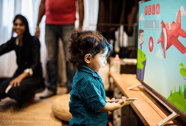 Young Indian boy watching television