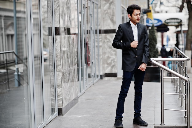 Young indian man on suit posed outdoor