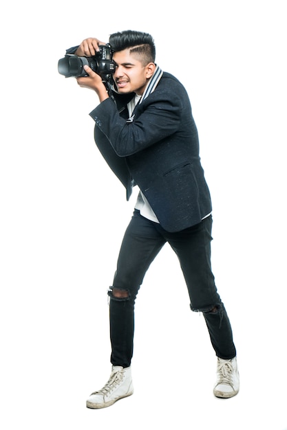 Free photo young indian man with camera isolated over white background