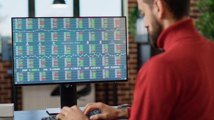 Free Photo young investor working on computer with real time stock charts, following trade market sales trend. financial analyst using forex exchange statistics to plan data analysis, index profit. close up.
