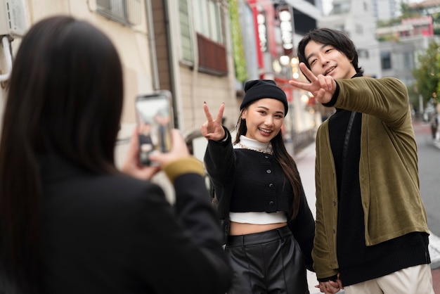 Free photo young japanese influencer recording vlog