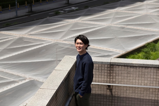 Young japanese man in a blue sweater