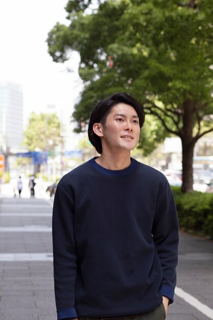 Young japanese man in a blue sweater