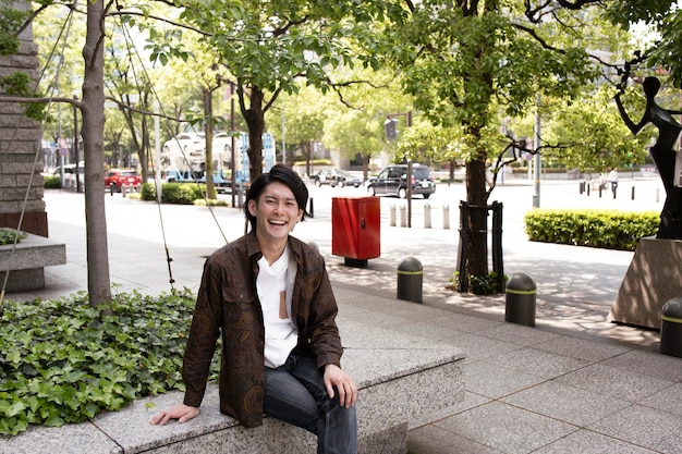 Young japanese man spending time outdoors alone