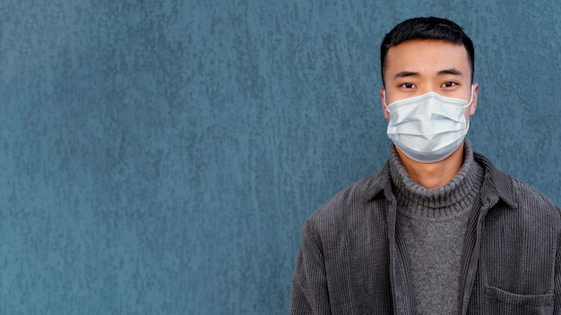 Free photo young japanese man wearing mask