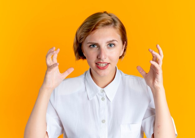 young joyful blonde russian girl stands with raised hands