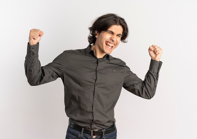 Young joyful handsome caucasian man raises fists up isolated on white background with copy space