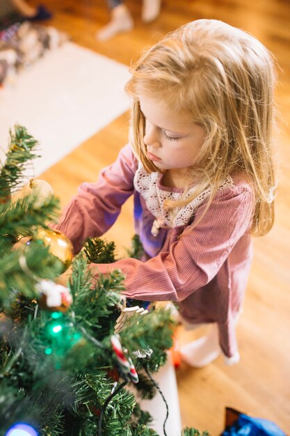 Young kid decorating christmas tree