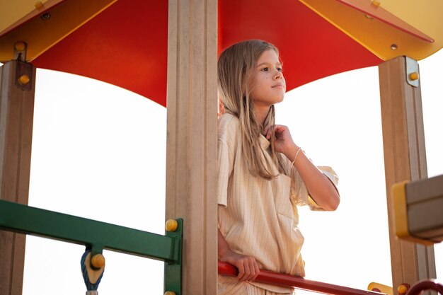 Young kid having fun at the outdoors playground