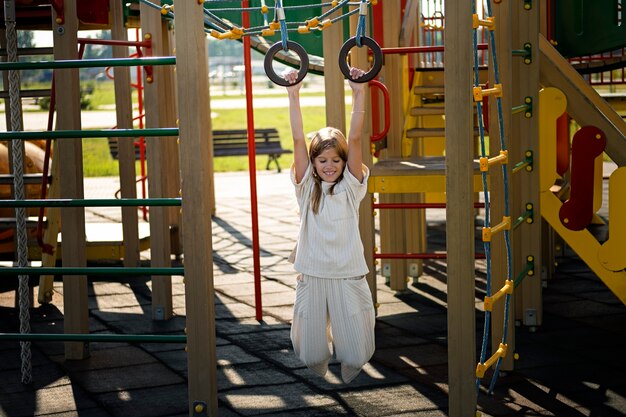 Young kid having fun at the outdoors playground