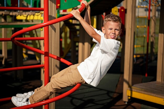 Young kid having fun at the outdoors playground