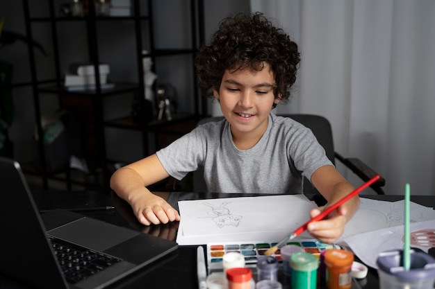 Young kid painting with watercolor