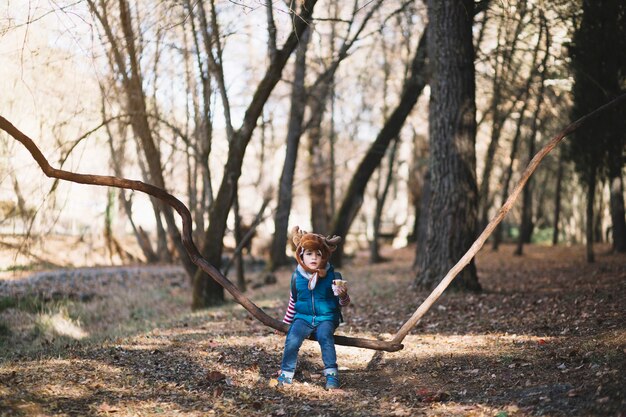 Young Kid Sitting on Branch – Free Stock Photo Download