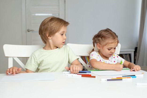 Free photo young kids drawing