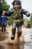 Free photo young kids enjoying childhood happiness by playing in the puddle of water after rain