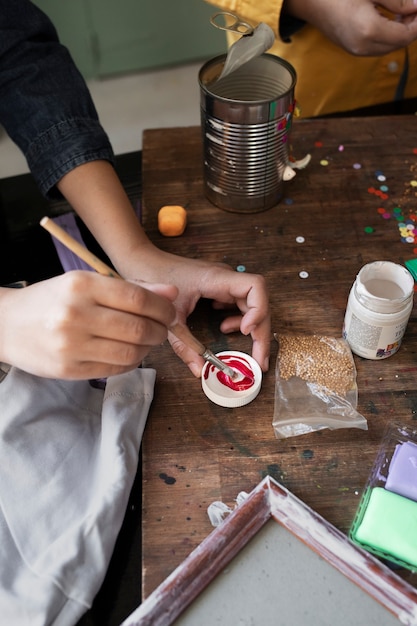 Young kids making diy project from upcycled materials