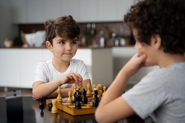 Free photo young kids playing chess together