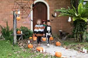 Free photo young kids trick or treating during halloween