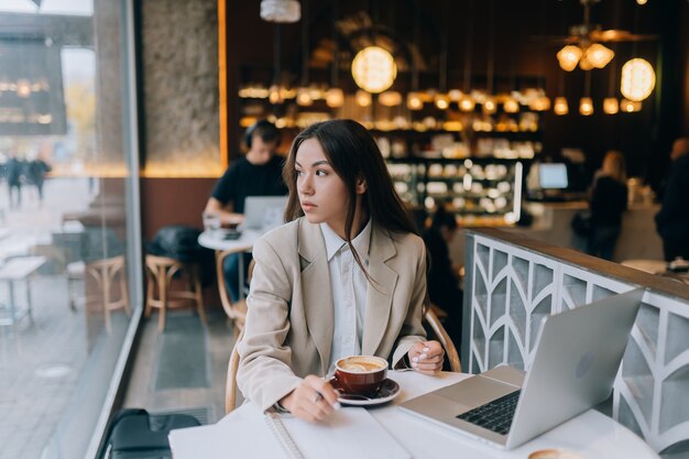 Young lady browsing the internet at the cafe