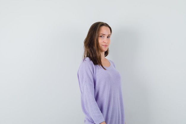 Free photo young lady in casual shirt looking at camera and looking sensible