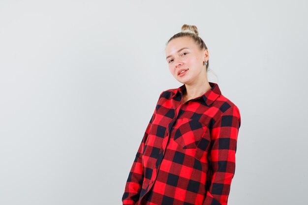 Young lady in checked shirt and looking delightful